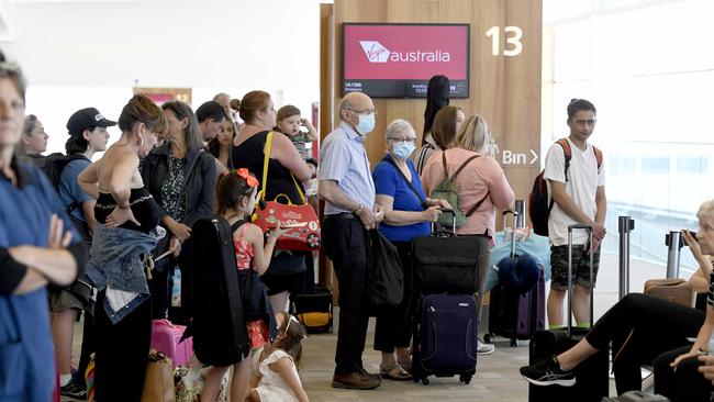 Passengers wait to board a plane to Brisbane at Adelaide Airport after the announcement that the city is going into a three-day lockdown. Picture: Naomi Jellicoe