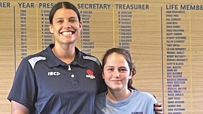 Young rugby player Belle Campbell and Waratahs player Sabine Blakeman.