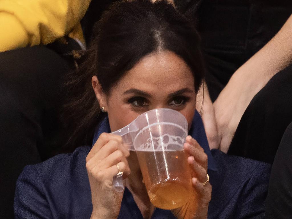 Meghan was pictured sipping away as they watched the match. Picture: George Rogers/SIPA/Mega Agency