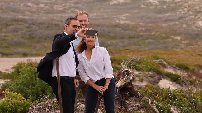 South Australian Premier Steven Marshall and owners Hayley and James Baillie take a selfie on the site of the Great Ocean lodge in Kangaroo Island. Picture: David Mariuz