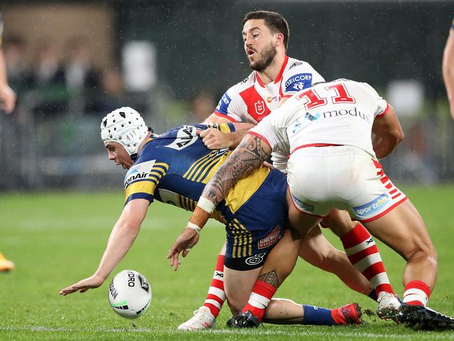 Reed Mahoney of the Eels drops the ball in a tackle by Ben Hunt and Tyrell Fuimaono of the Dragons. Picture: Mark Kolbe/Getty Images