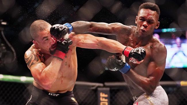 *This picture has been selected as one of the Best of the Year Sports images for 2019*  Robert Whittaker of Australia is hit by Israel Adesanya of New Zealand as they compete during UFC 243 at Marvel Stadium in Melbourne, Sunday, October 6, 2019. (AAP Image/Michael Dodge) NO ARCHIVING,EDITORIAL USE ONLY