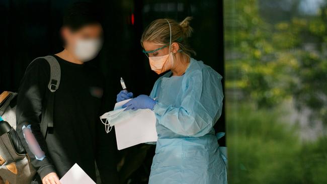 Patient in mask being seen by triage nurse at Northern Beaches Hospital's new COVID-19 clinic. Picture: Tim Pascoe