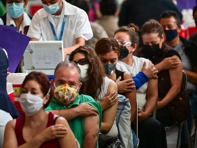 People wait after receiving doses of the Pfizer-BioNTech vaccine at a hub in Mexico City. Picture: Pedro Pardo/AFP