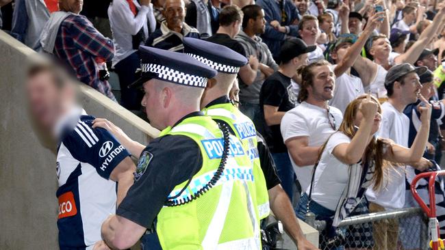 ADELAIDE United v Melbourne Victory at Coopers Stadium – A Victory fan is escorted from the field