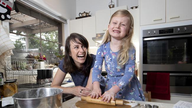 Emily Paddon Brown and her daughter Molly, 4, baking in their kitchen at home in Coburg. Picture: David Geraghty