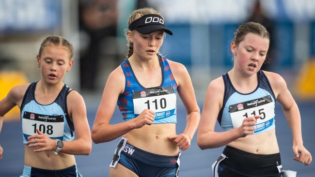 Maisie Mitchell is flanked by Jessica Loring from Northmead NSW (athlete 105) who finished second and Matilda Webb from Winston Hills (athlete 115) who finished third in the 3000m walk.