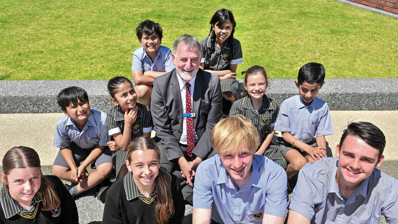 Former Port Adelaide SANFL player and chief executive Paul Belton has always loved education, even during his playing career. With year 4 students, Giuseppe and Aaliyah, year 2 students Carlos, Aishvir, Aria and Aarav, year 8 students Skye and Mila and year 11 students Jackson and Bradley. Picture: Brenton Edwards