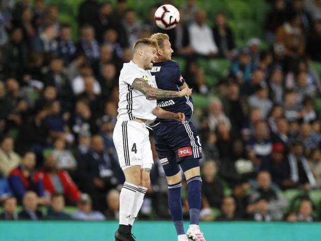 Victory’s Georg Niedermeier (right) and Wellington’s Armando Sosa Pena contest a header. Picture: AAP 