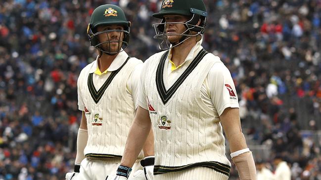 Travis Head and Steve Smith walk from the ground as rain stops play on day one. Picture: Getty Images