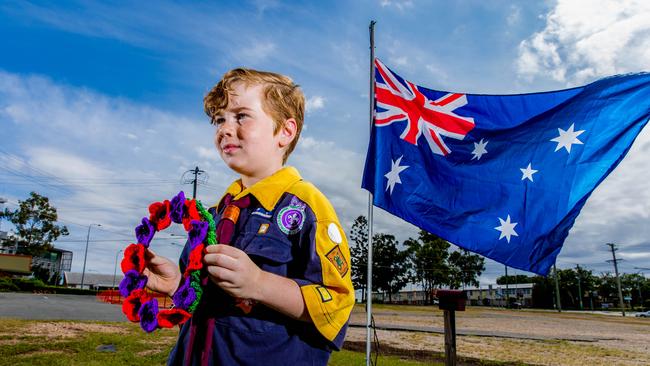 Eight-year-old Robert Kaden from Marsden Scouts outside his Logan Central house, They have built a flagpole to commemorate ANZAC Day - Picture: Richard Walker