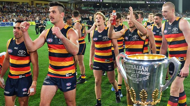 Adelaide players walk past the premiership cup, which they will be playing for next Saturday. Picture: Getty