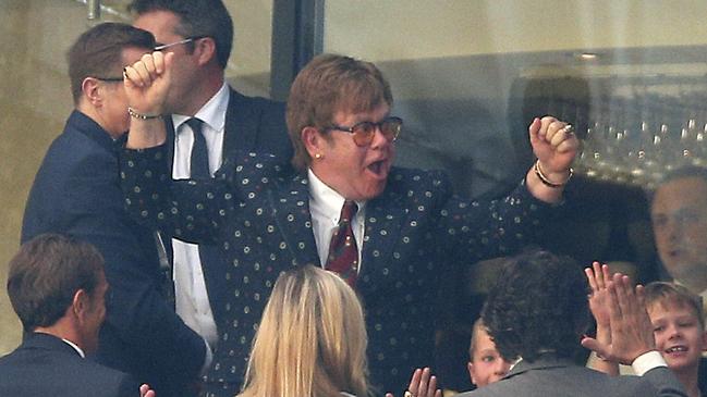 Former Watford owner Elton John celebrates in the stands after the English Premier League soccer match between Watford and Tottenham Hotspur at Vicarage Road, Watford, England, Sunday, Sept. 2, 2018. (Nigel French/PA via AP)