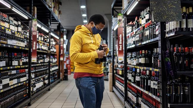 A customer buys alcohol at a liquor shop in Craighall Park, Johannesburg. Picture: AFP