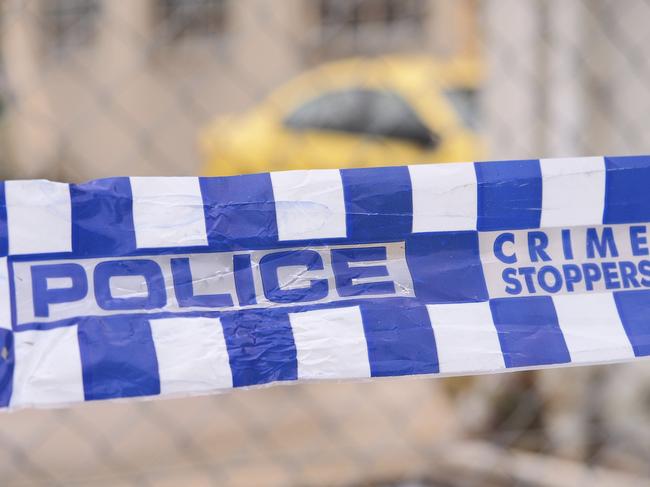 Blue and white Police tape cordoning off a area with a yellow car at a industrial area, Australia 2016Police tape cordoning off a area with a yellow car - Stock image  ipad generic