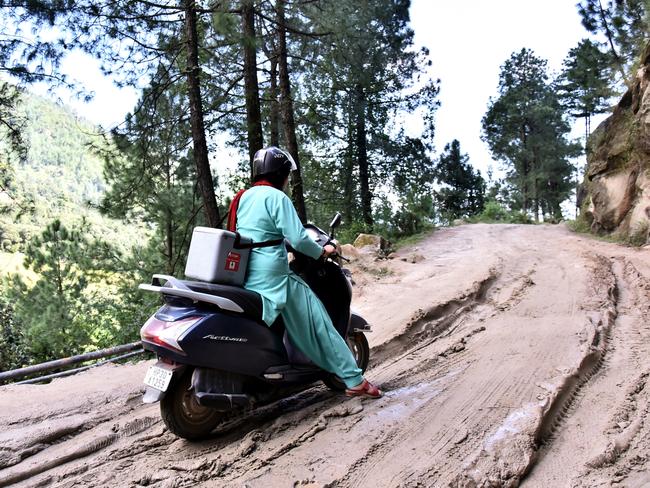 A health worker travelling on motorbike in the hard to reach village Shankar Dehra, Tehsil Thunag, District Mandi, Himachal Pradesh, India. Picture: UNICEF India/Ashutosh Sharma