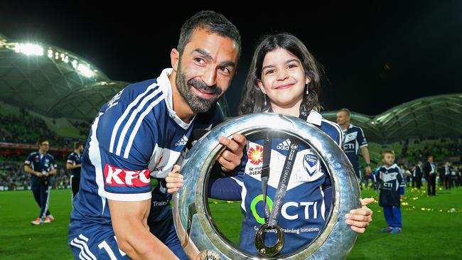 Fahid Ben Khalfallah of the Victory and his daughter celebrate with the trophy