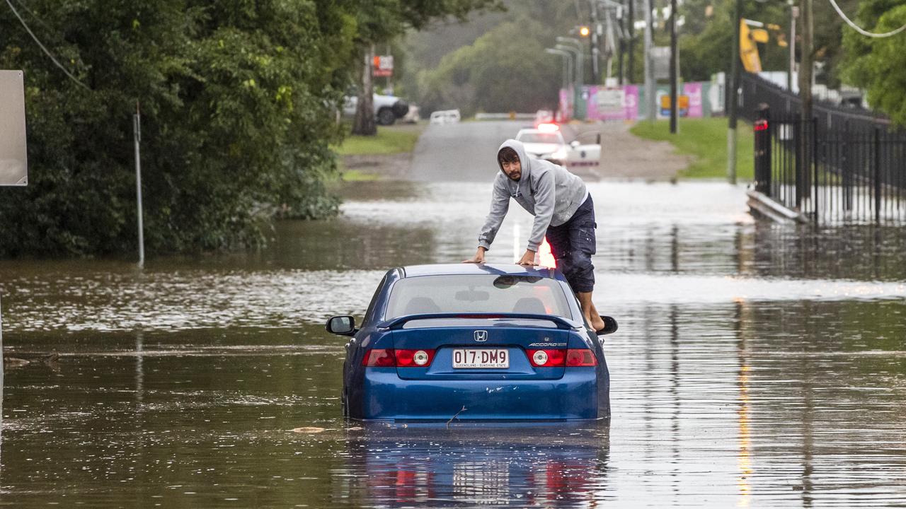 The man climbs on to the roof of his car after the vehicle stops. Picture: Richard Walker