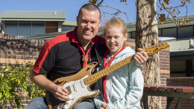 Adam Wardell, who is playing guitar in the Cumberland Gang Show, with 10-year-old daughter Keira who is also part of the show. Picture: Tim Searle Photography