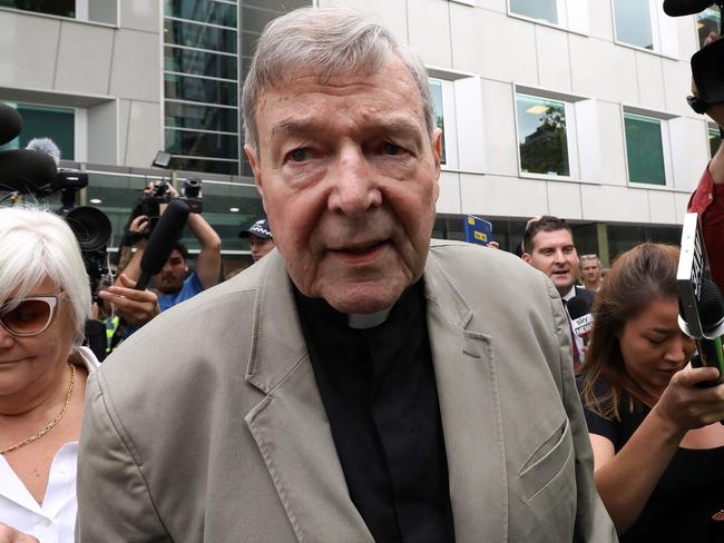 (FILES) In this file photo taken on February 26, 2019 Cardinal George Pell (C) leaves the County Court of Victoria court after prosecutors decided not to proceed with a second trial on alleged historical child sexual offences in Melbourne. - Disgraced Australian Cardinal Pell was sentenced to six years in jail for child sex crimes in a Melbourne court on March 13, 2019, with a non-parole period of three years and eight months. (Photo by Asanka Brendon Ratnayake / AFP)