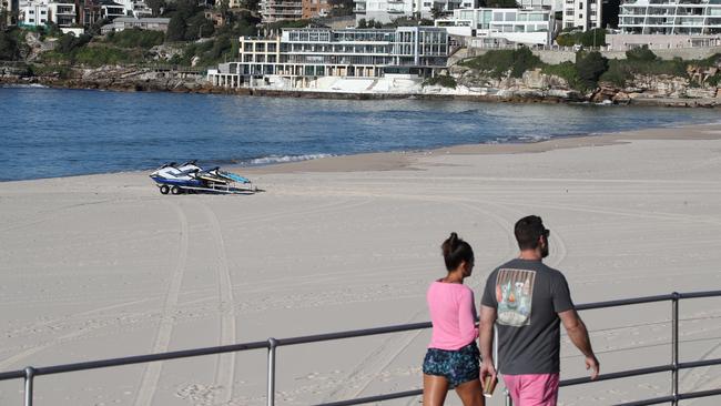 People at Bondi on Monday morning seem to be observing good social distancing while on their morning walks. Picture: David Swift