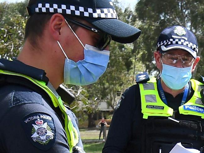 Police detain an anit-lockdown protester in the Melbourne suburb of Elsternwick on September 19, 2020. - Melbourne continues to enforce strict lockdown measures to battle a second wave of the coronavirus. (Photo by William WEST / AFP)