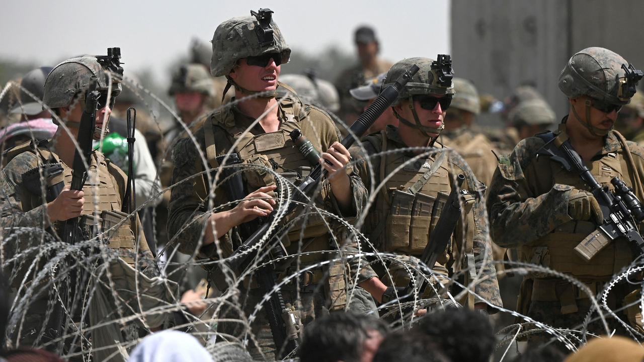 US soldiers stand guard behind barbed wire at Kabul airport. Picture: Wakil Kohsar/AFP