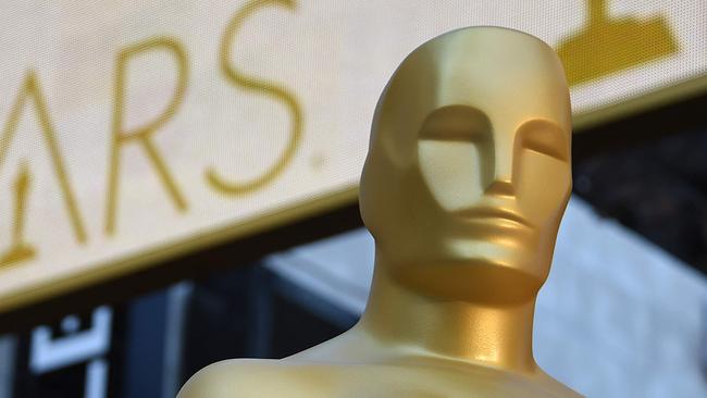 (FILES) In this file photo an Oscar statue is seen at the red carpet arrivals area as preparations continue for the 88th Annual Academy Awards at Hollywood & Highland Center on February 25, 2016 in Hollywood, California. - Streaming films like "Mank" and "The Trial of the Chicago 7" will battle with frontrunner "Nomadland" for the March 15, 2021 coveted Oscar nominations, setting up the grand finale to an awards season transformed by the pandemic. With most US movie theaters closed all year due to Covid, the Academy Awards have been delayed to their latest-ever date -- April 25 -- while several big-screen studio blockbusters skipped their 2020 releases entirely, leaving an eclectic field of hopefuls. (Photo by ROBYN BECK / AFP)