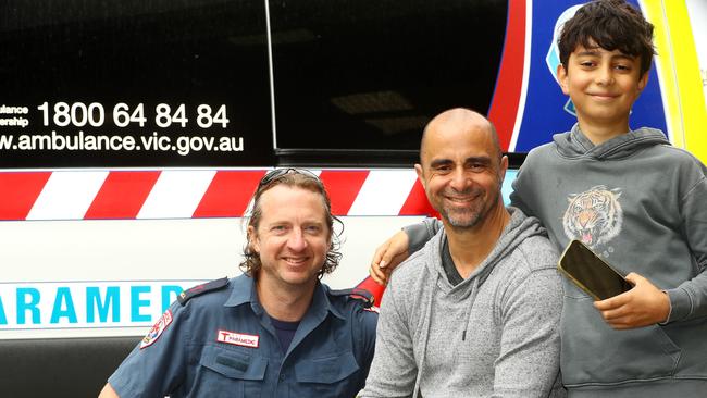 Chris Liontos with son Luca, 10, and first on the scene Paul Bragg, a paramedic who lives nearby and was off-duty at the time of the arrest. Picture: Alison Wynd