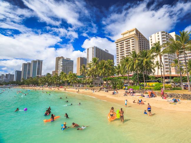 ESCAPE:  Waikiki, Oahu, Hawaii, United States - August 27, 2016: summertime in crowded Prince Kuhio Beach also called The Ponds because a concrete wall makes the water calm. Kuhio Beach is a section of Waikiki Beach. Picture: Istock