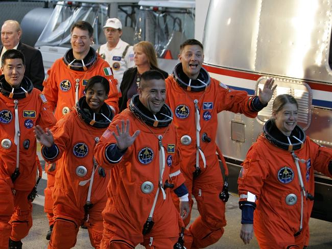 The astronauts on Space Shuttle Discovery including Pamela Melroy, the first woman to command a space shuttle.