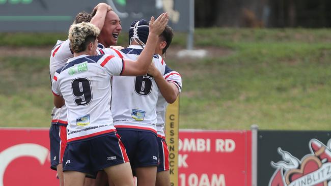 The Roosters celebrate a try. Picture: Sue Graham