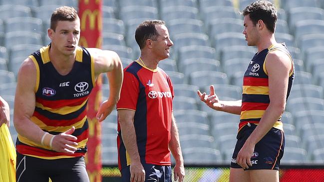 Don Pyke talks to Mitch McGovern at Adelaide Oval on Wednesday as the young forward tried to prove his fitness. Picture: Sarah Reed