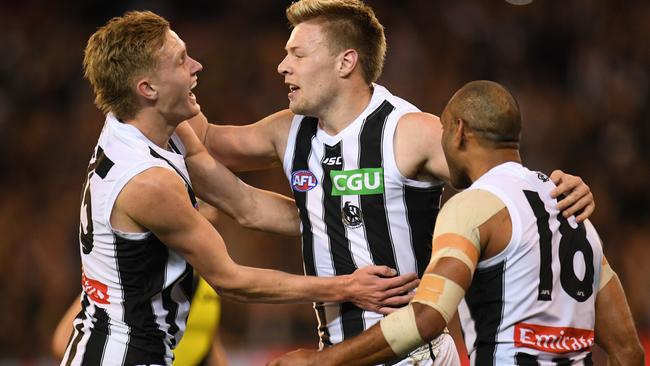 Jaidyn Stephenson, Jordan De Goey and Travis Varcoe celebrate a goal. Picture: AAP Image/Julian Smith.