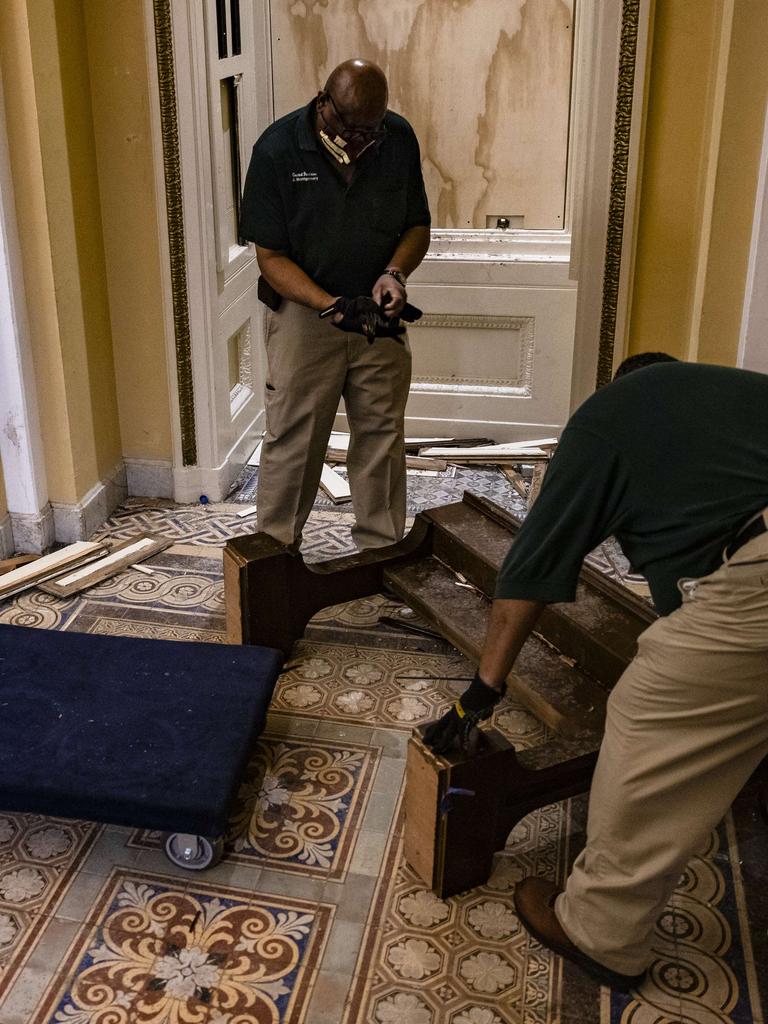 Workers begin to clean up the debris and damage in the Capitol building. Picture: Getty Images/AFP