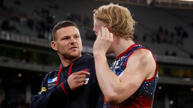 Injured Dee Steven May chats to Clayton Oliver after the loss.