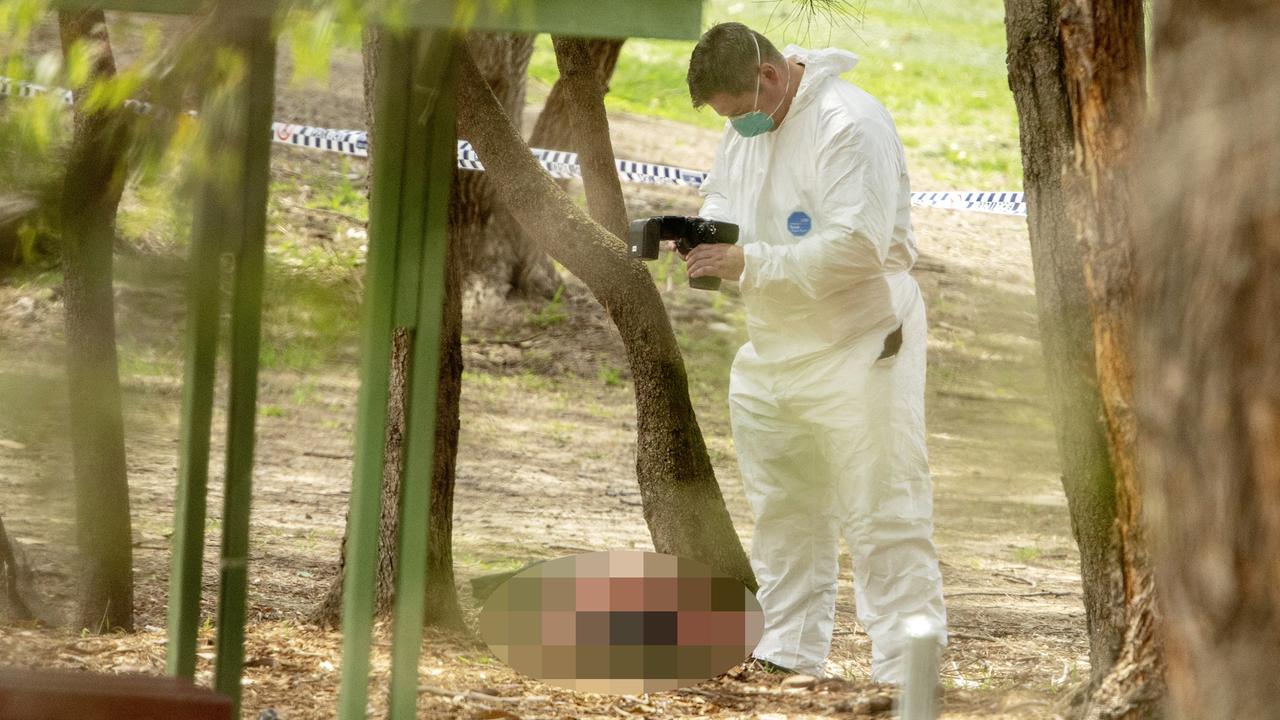 The body of a woman found at Buffalo Creek reserve is photographed by a forensic officer at a playground at Hunters Hill Picture: Jenny Evans.