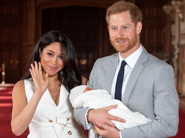 A friendly wave! The Duchess and Duke of Sussex, pictured for the first time with their son Archie Harrison Mountbatten-Windsor in in St George's Hall at Windsor Castle. Picture: AFP 