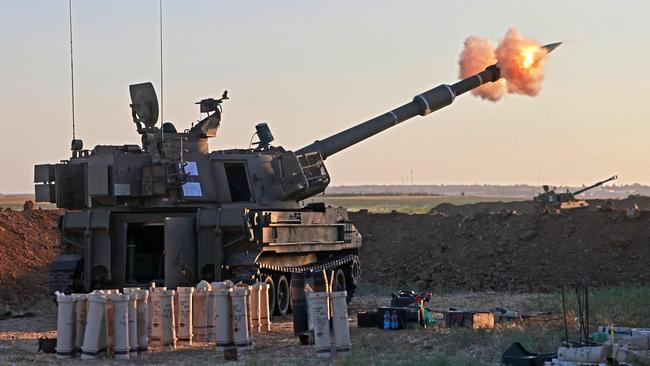 Israeli soldiers fire a 155mm self-propelled howitzer towards the Gaza Strip from their position along the border. Picture: AFP.