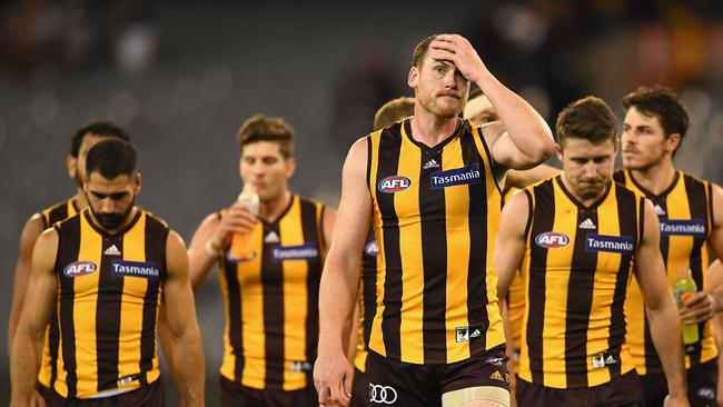 Jarryd Roughead looks dejected as he leads the Hawks off the field. Picture: Getty