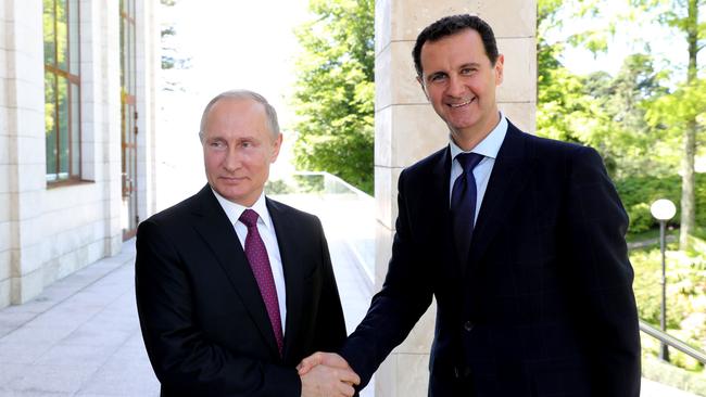 Russian President Vladimir Putin shakes hands with his Syrian counterpart Bashar al-Assad during their meeting in 2018. Picture: AFP