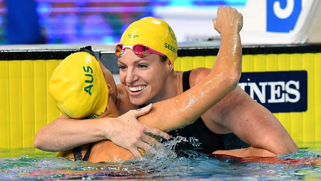 Emily Seebohm (right) of Australia is hugged by Holly Barratt of Australia after winning the Women's 50m Backstroke on day six of swimming competition at the XXI Commonwealth Games at Gold Coast Aquatic Centre on the Gold Coast, Australia, Tuesday, April 10, 2018. (AAP Image/Darren England) NO ARCHVIING, EDITORIAL USE ONLY