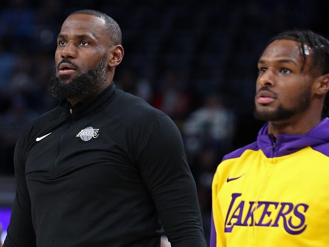 MEMPHIS, TENNESSEE - NOVEMBER 06: LeBron James #23 and Bronny James #9 of the Los Angeles Lakers look on before the game against the Memphis Grizzlies at FedExForum on November 06, 2024 in Memphis, Tennessee. NOTE TO USER: User expressly acknowledges and agrees that, by downloading and or using this photograph, User is consenting to the terms and conditions of the Getty Images License Agreement. (Photo by Justin Ford/Getty Images)