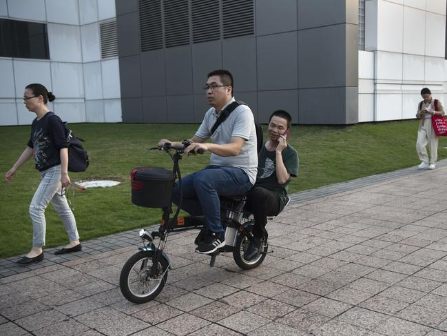 Huawei employees leave work for the weekend. Picture: Getty