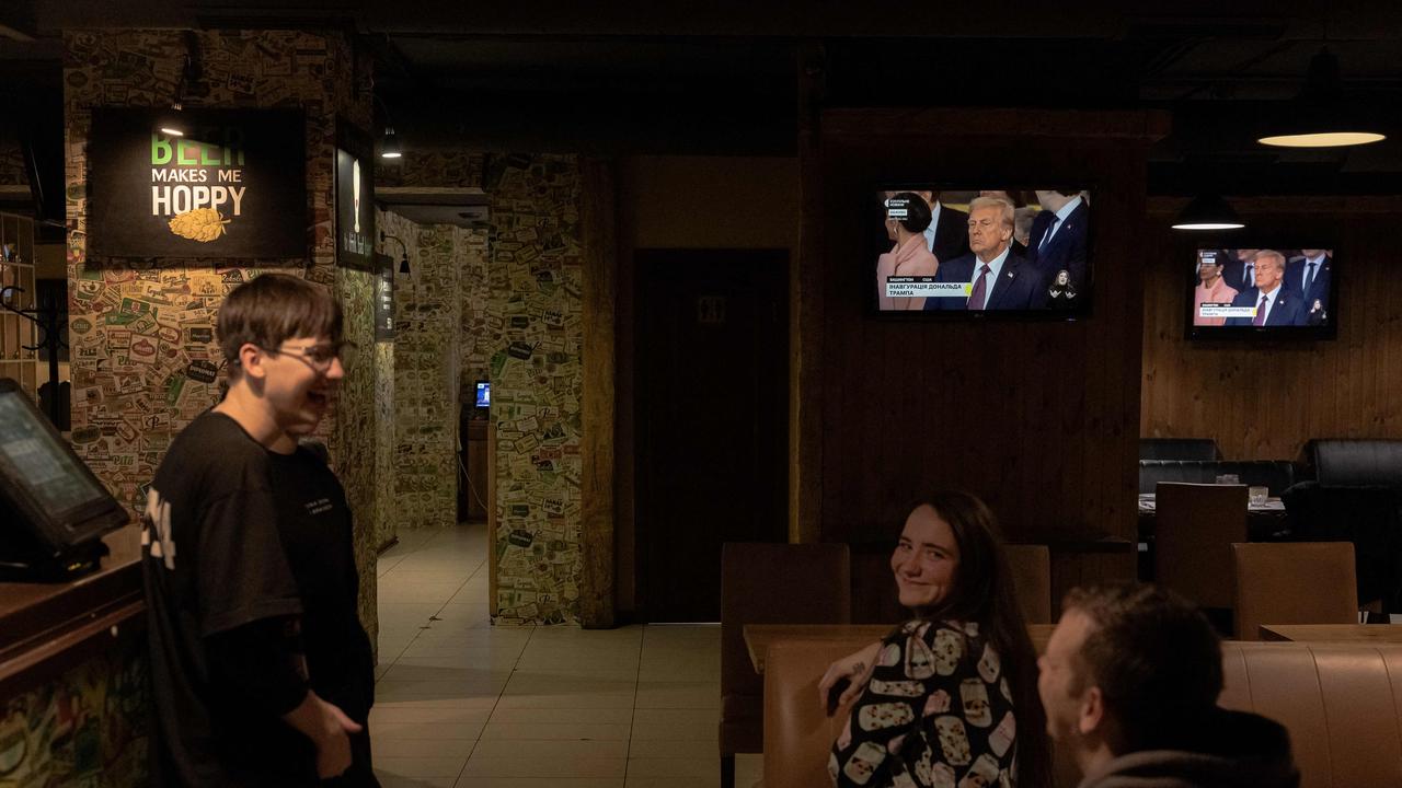 Restaurant employees watch the presidential inauguration of US President Donald Trump on television screens in Kyiv. Trump has repeatedly claimed he can end the conflict quickly but has provided no clear plan. Picture: Roman Pilipey / AFP