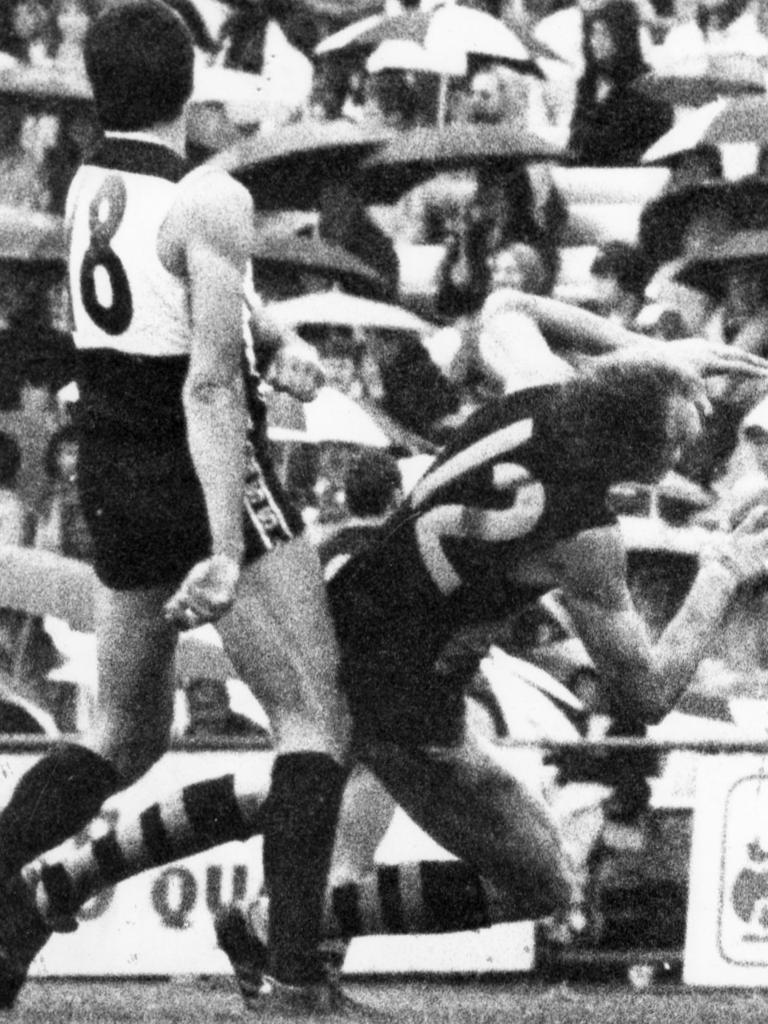 Glenelg’s Graham Cornes hits the deck after being hit by David Granger in the controversial 1982 SANFL preliminary final at Football Park. Picture: Tony Lewis