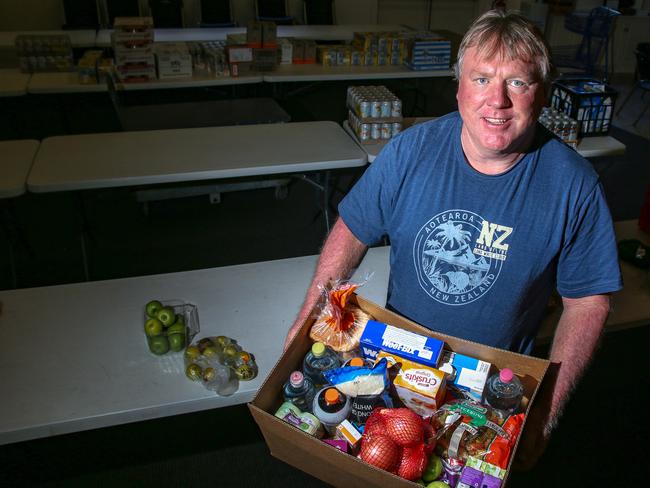 GIVE AWAY: Gatton Seventh Day Adventist church pastor Darryl Groves with a food hamper. Picture: Dominic Elsome