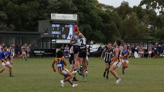 Crib Point's Brad Arnold (No. 2) takes a mark. Picture: Euan Poulton