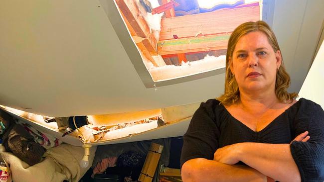 Jodie Davis inside her shattered home after a tree slammed into her roof cracking the ceiling and leaving a gaping hole into her walk-in wardrobe. Picture: Contributed