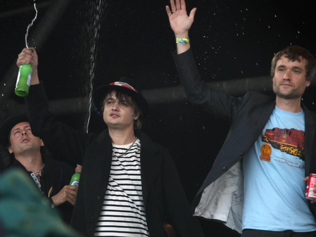 Carl Barat, Pete Doherty and John Cory Hassall of The Libertines wave to fans as they arrive on the Pyramid stage during the 2015 Glastonbury Music Festival. Picture: AAP